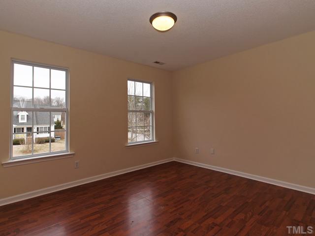 740 Rockville Road Wake Forest, NC 27587 - Photo 18 of 25 an empty room with wooden floor and windows