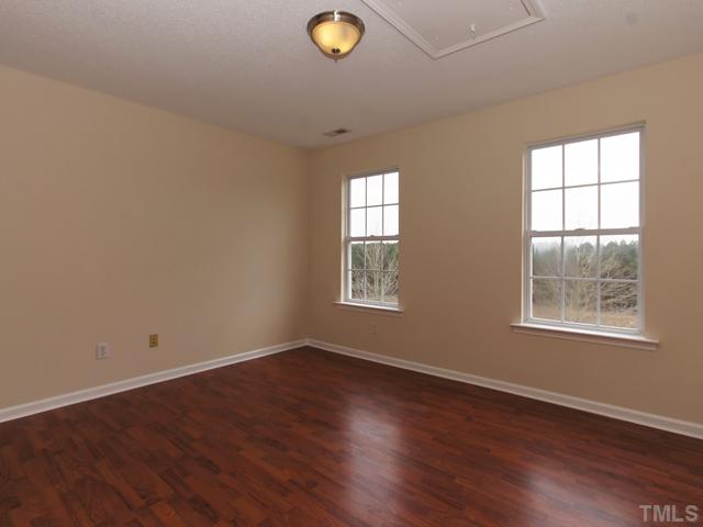 740 Rockville Road Wake Forest, NC 27587 - Photo 19 of 25 an empty room with wooden floor and windows