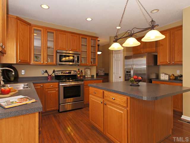 740 Rockville Road Wake Forest, NC 27587 - Photo 5 of 25 a kitchen with stainless steel appliances granite countertop a stove a sink and a microwave