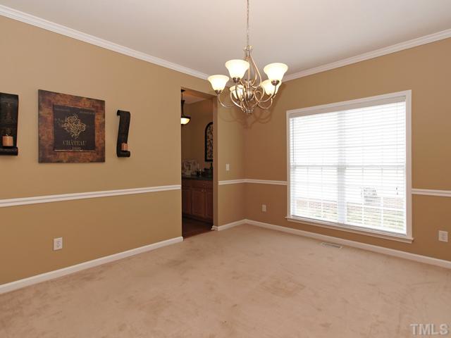 740 Rockville Road Wake Forest, NC 27587 - Photo 8 of 25 a view of a livingroom with a chandelier fan and windows