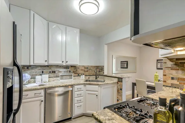 a kitchen with a sink stove and cabinets