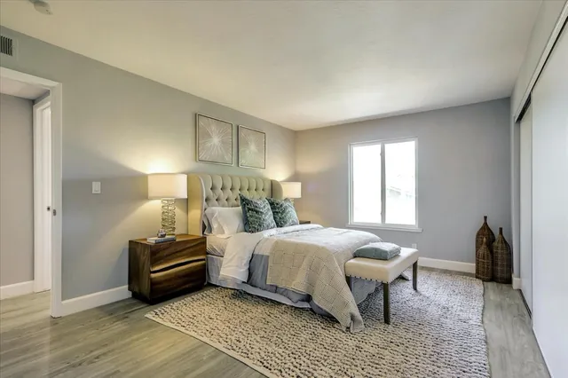 a bedroom with a bed and a lamp