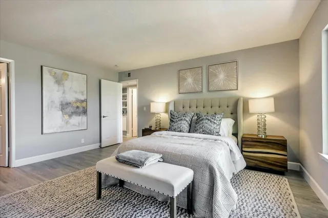 a bedroom with a bed and a lamp on table