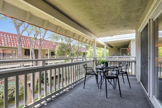 a view of a chairs and table in the balcony