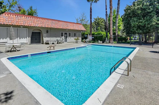 a view of a house with swimming pool and sitting area