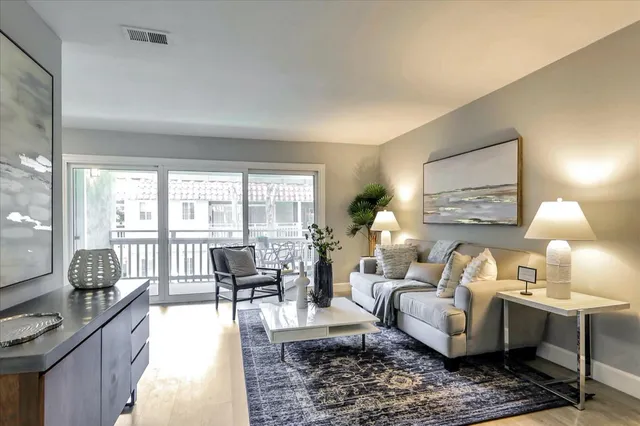 a living room with furniture and a lamp