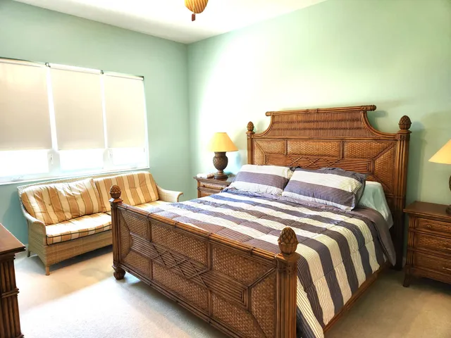 a bedroom with a bed and a couch