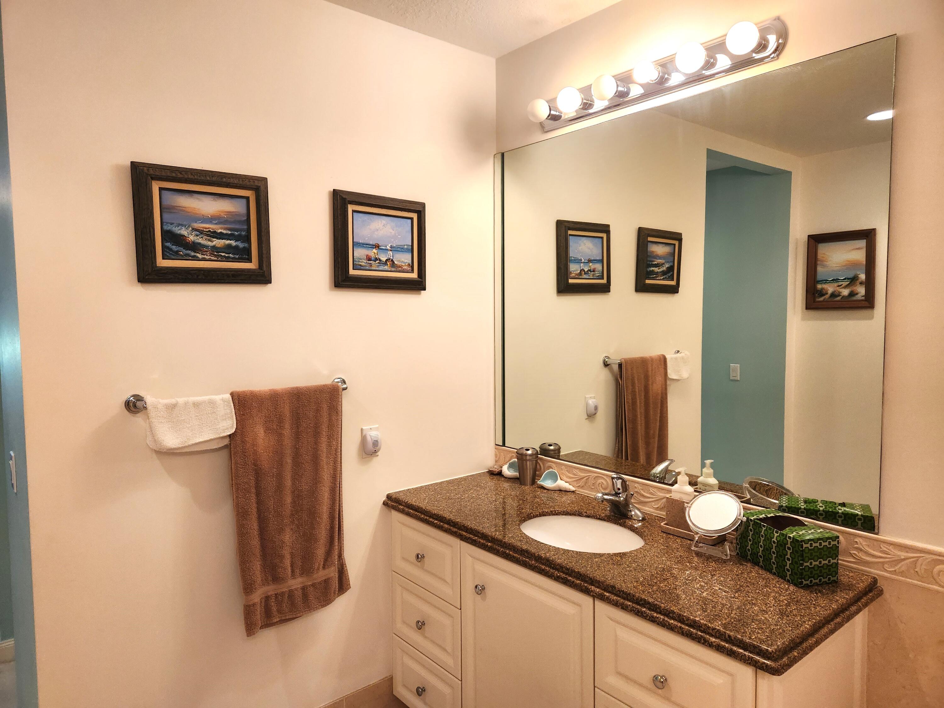 1 Harbour Isle Drive East, Unit 104 Fort Pierce, FL 34949 - Photo 16 of 28 a bathroom with a sink and a mirror