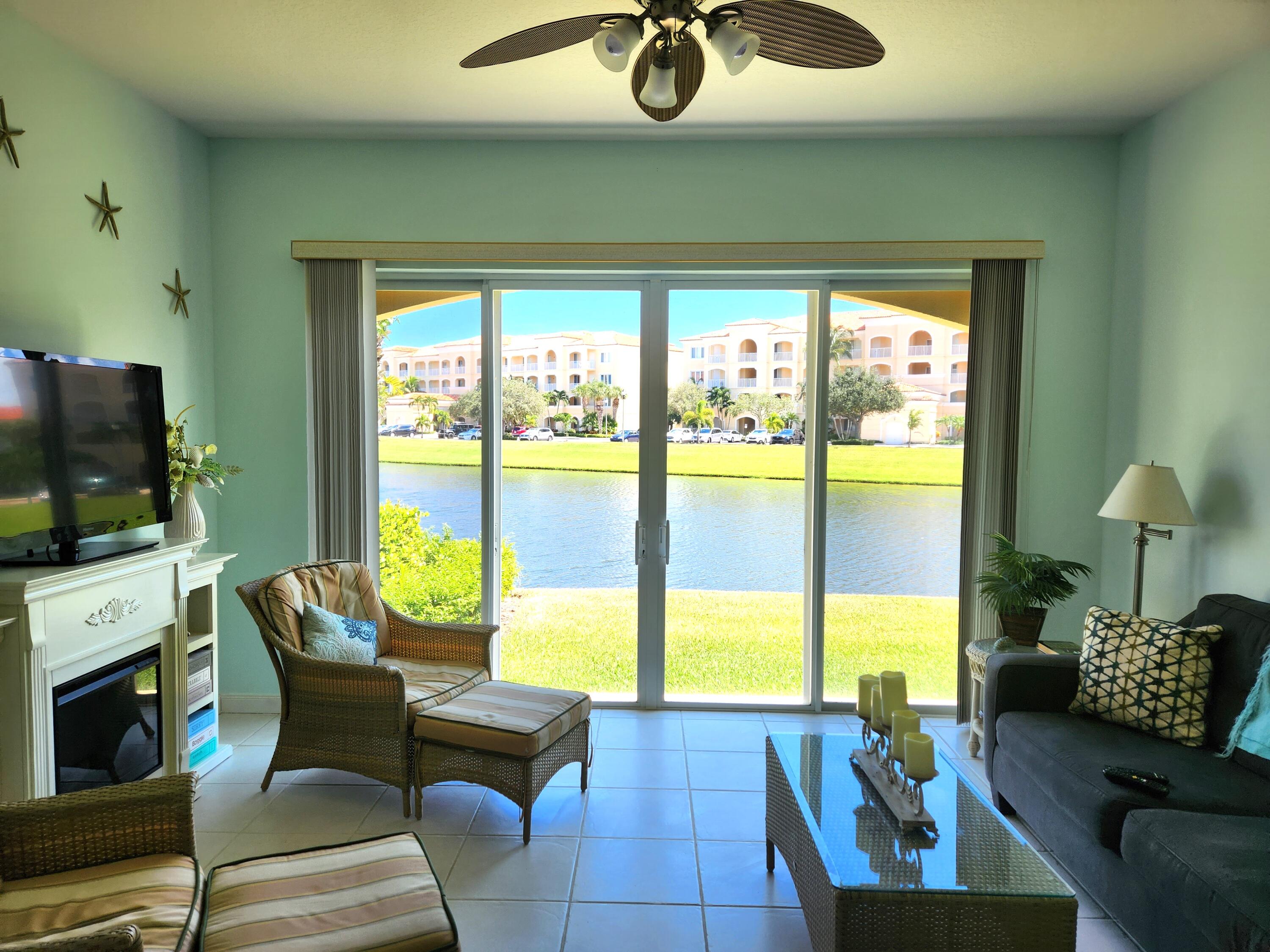 1 Harbour Isle Drive East, Unit 104 Fort Pierce, FL 34949 - Photo 2 of 28 a living room with furniture and a flat screen tv