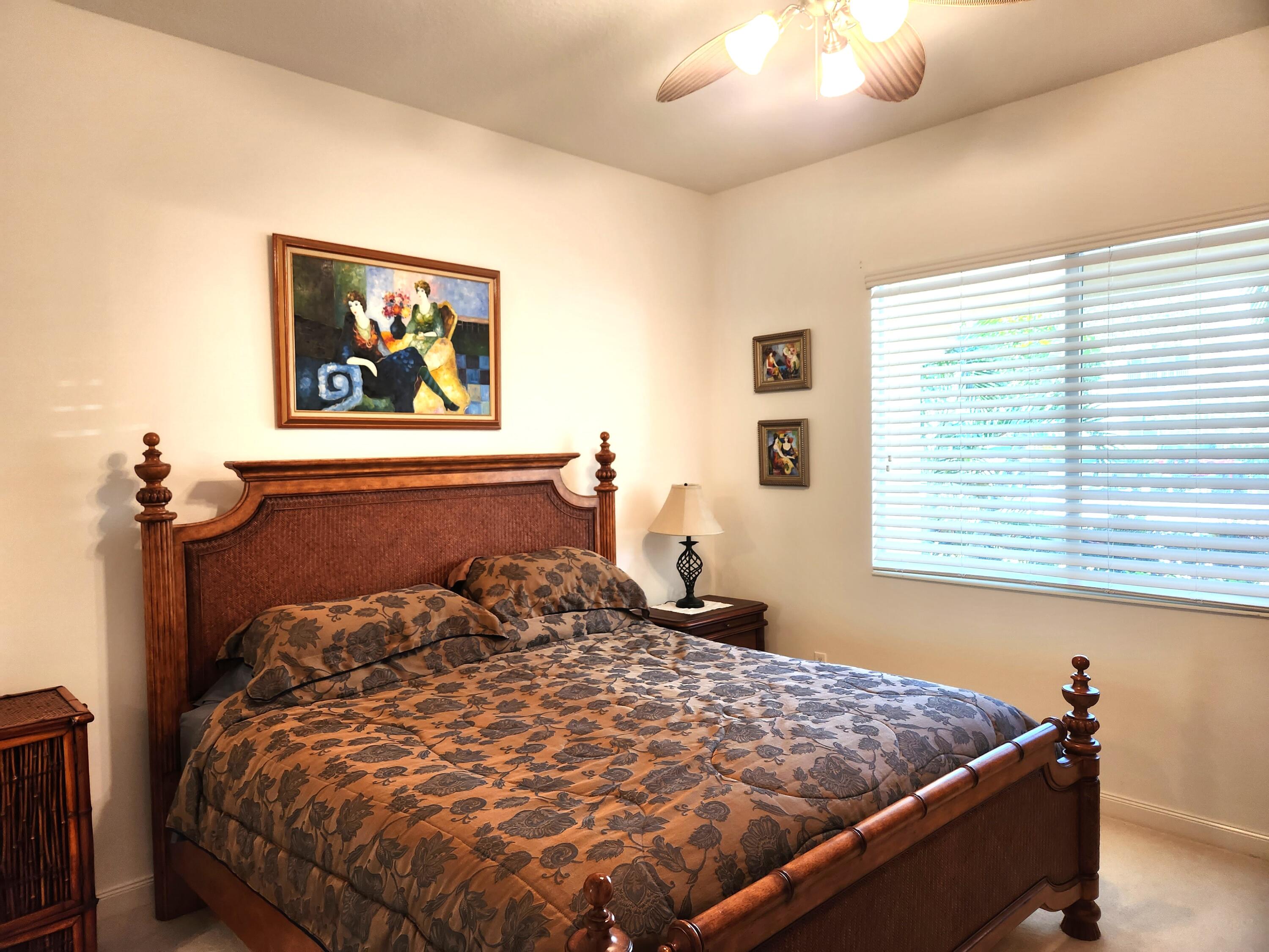 1 Harbour Isle Drive East, Unit 104 Fort Pierce, FL 34949 - Photo 21 of 28 a bed sitting in a bedroom next to a window