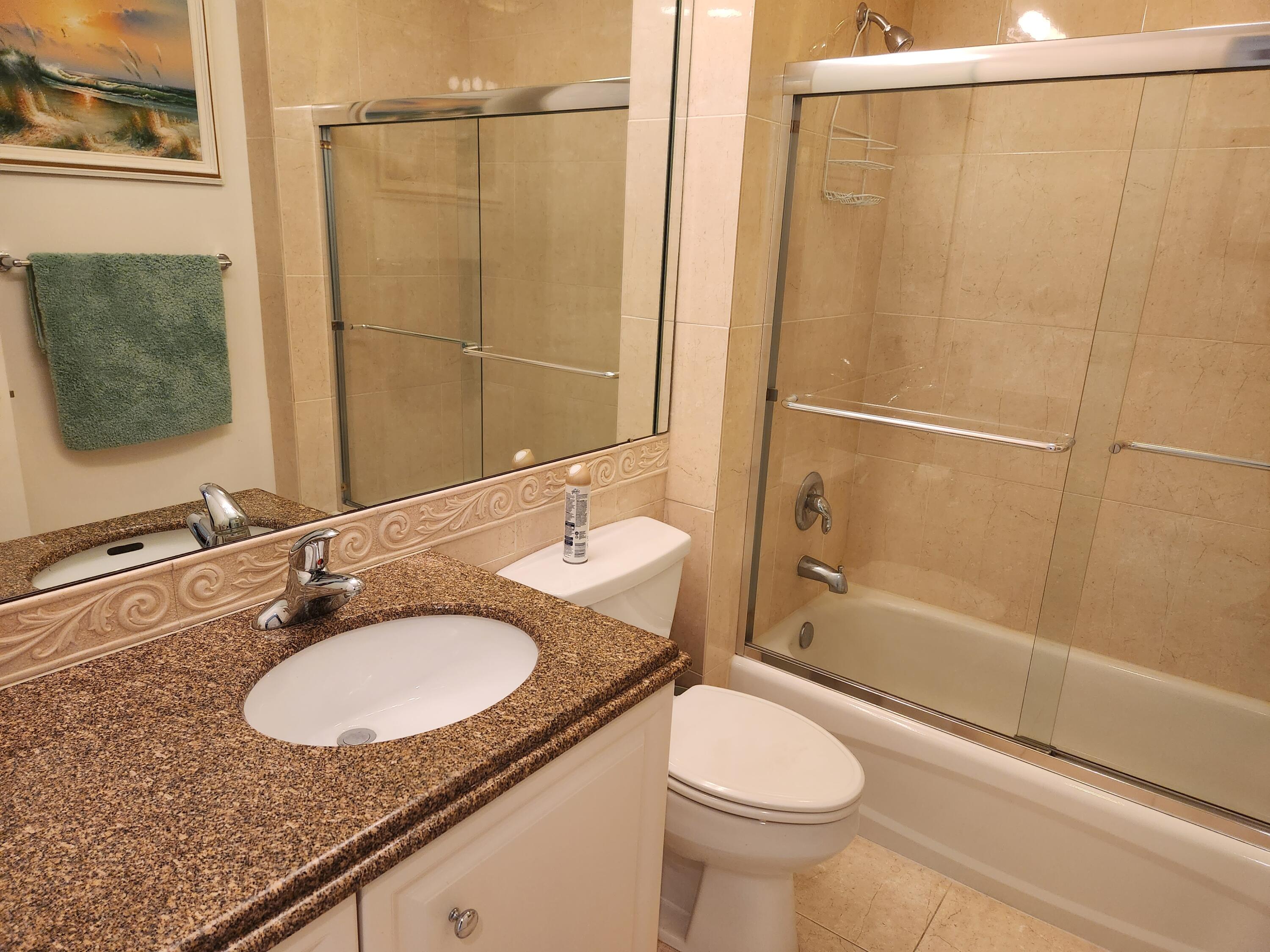 1 Harbour Isle Drive East, Unit 104 Fort Pierce, FL 34949 - Photo 23 of 28 a bathroom with a sink toilet and shower