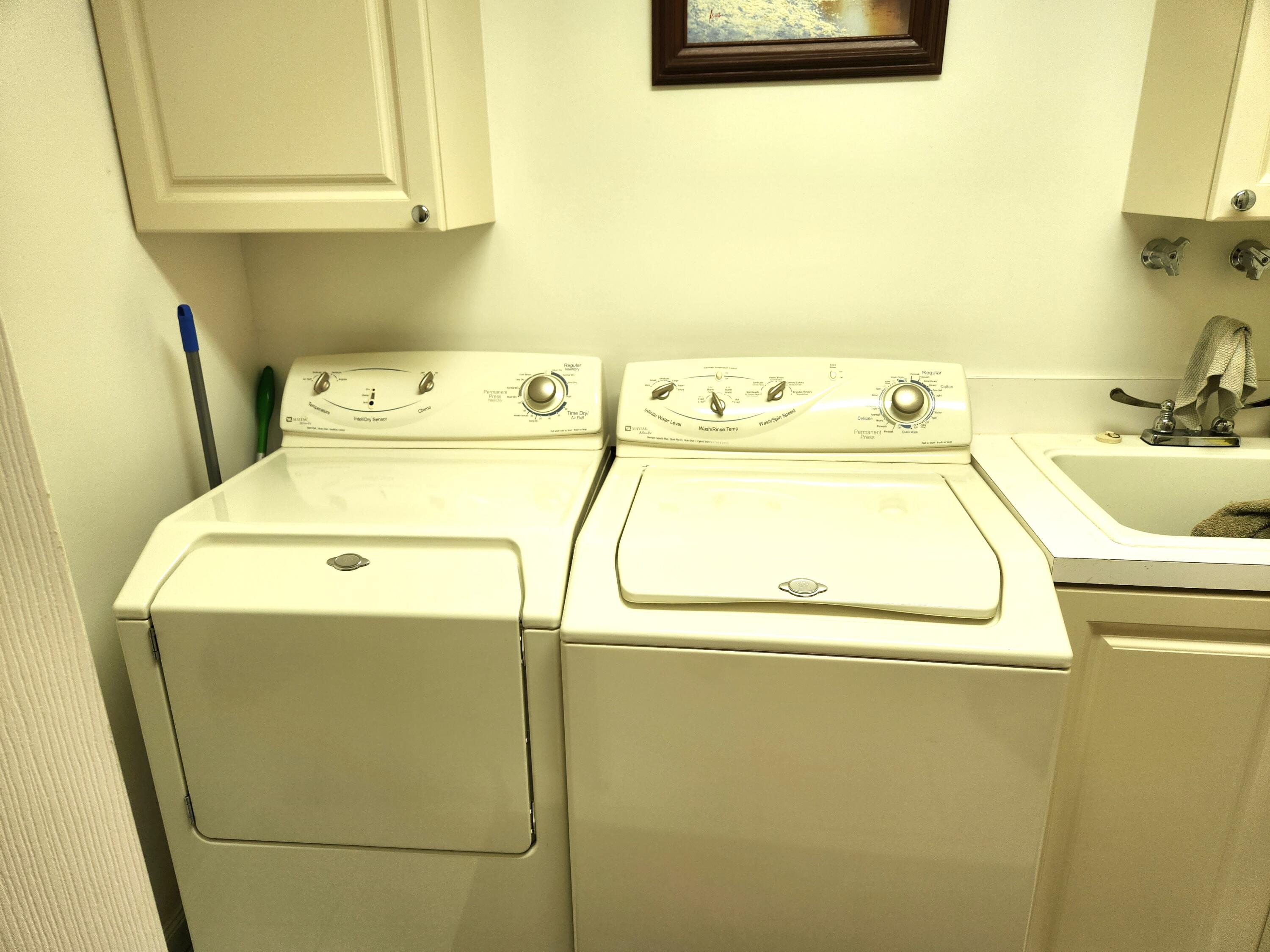 1 Harbour Isle Drive East, Unit 104 Fort Pierce, FL 34949 - Photo 26 of 28 a utility room with dryer and washer