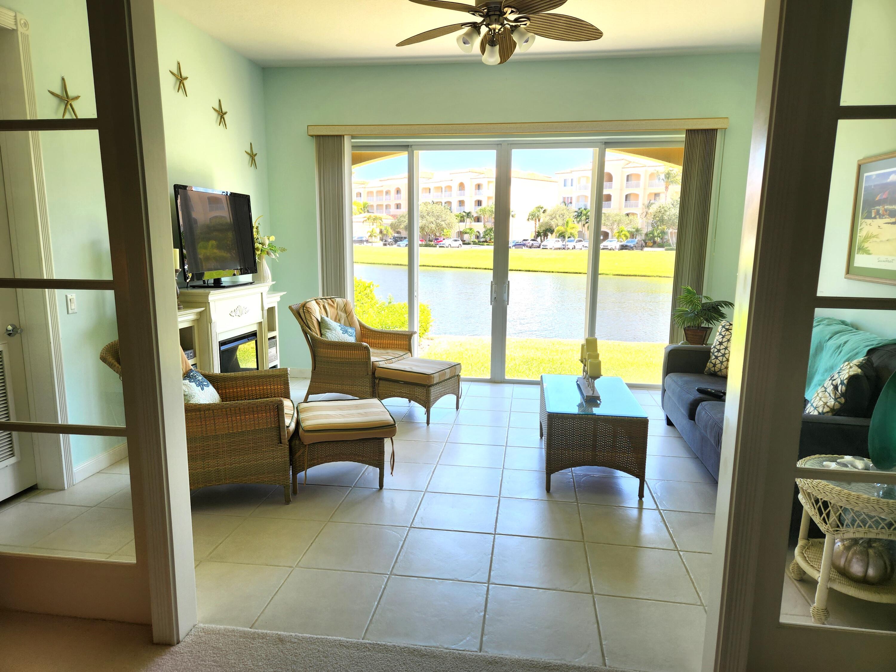 1 Harbour Isle Drive East, Unit 104 Fort Pierce, FL 34949 - Photo 27 of 28 a living room with furniture and a floor to ceiling window