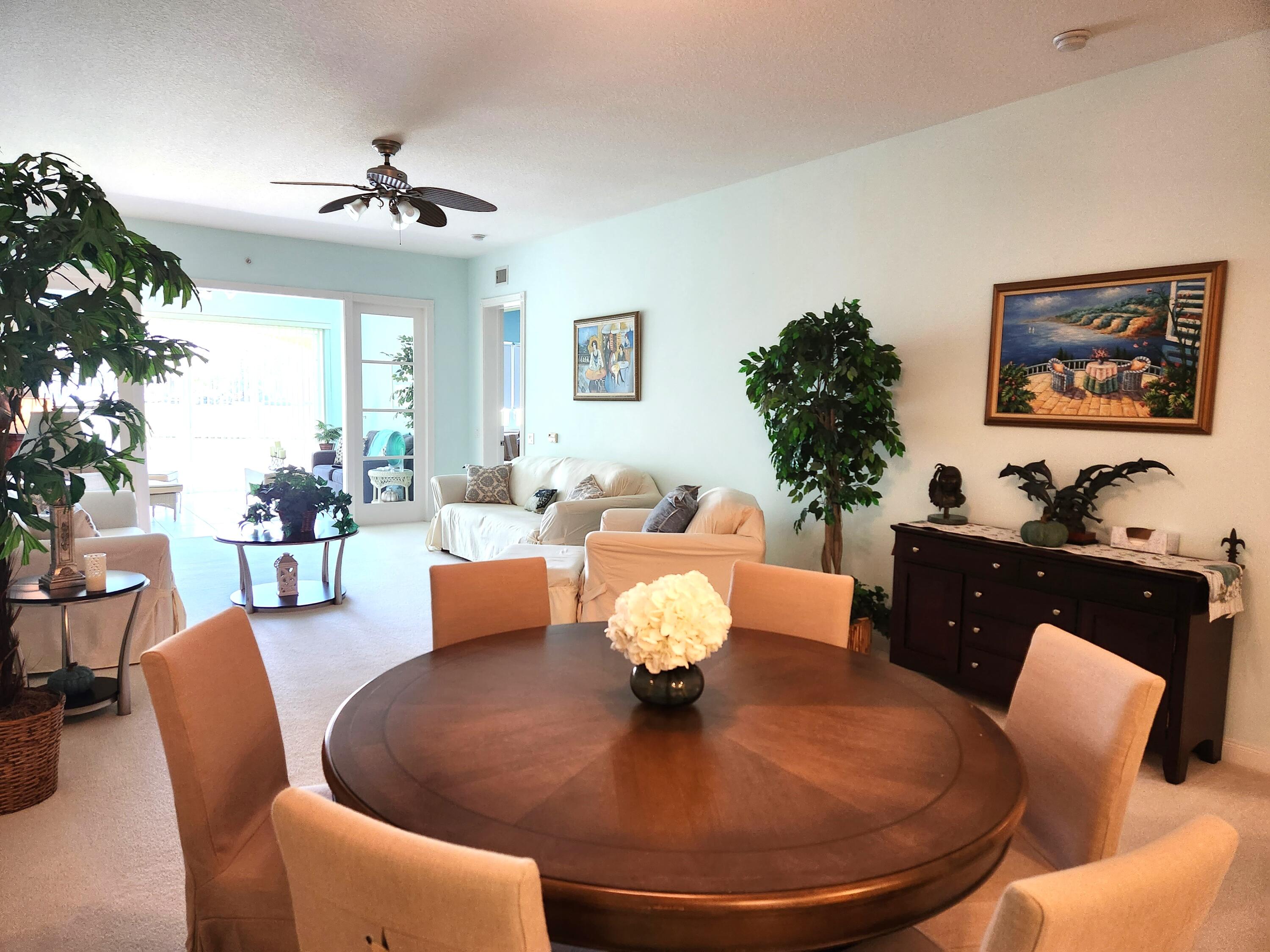 1 Harbour Isle Drive East, Unit 104 Fort Pierce, FL 34949 - Photo 3 of 28 a living room with furniture kitchen view and a chandelier