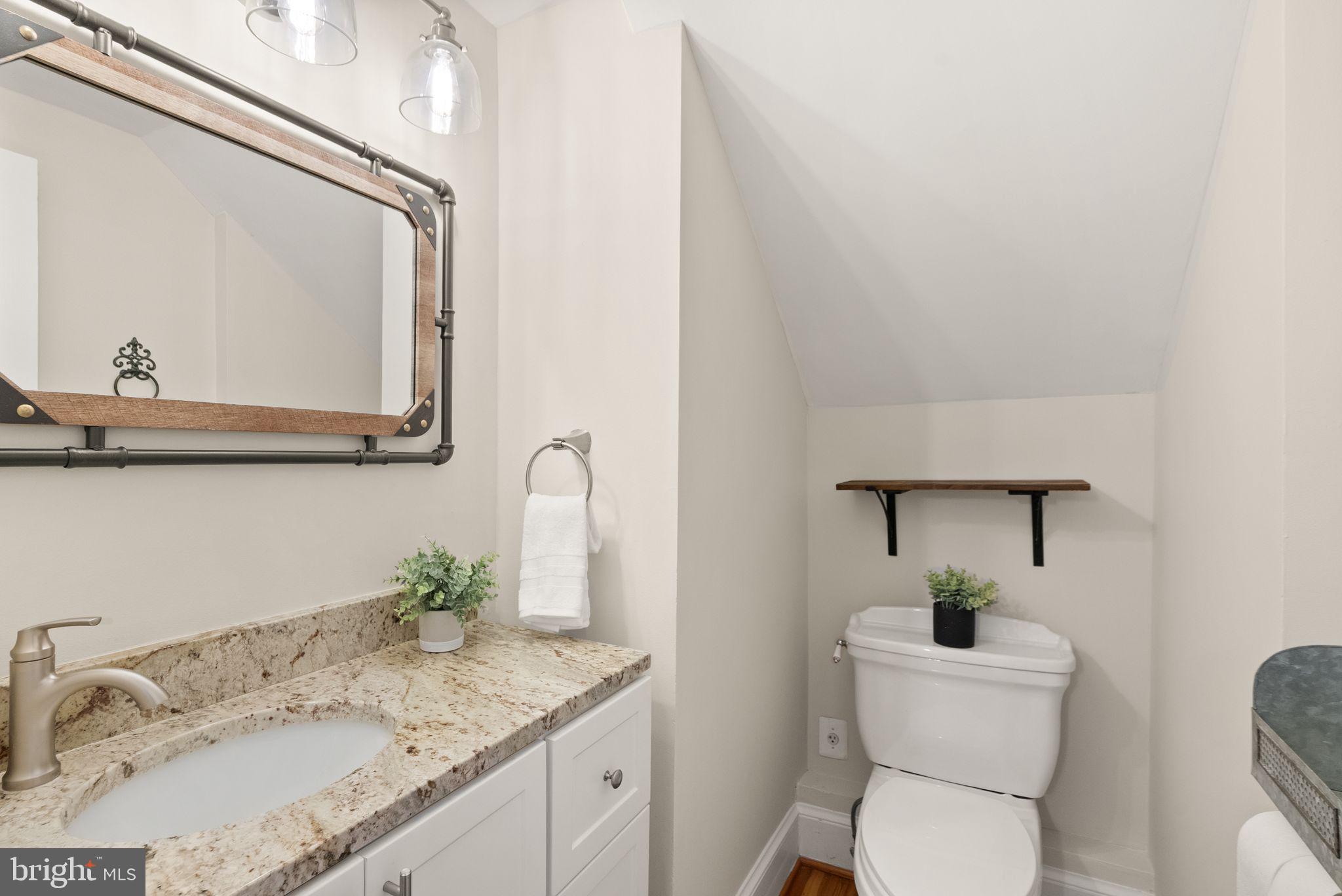 37151 Branchriver Road Purcellville, VA 20132 - Photo 25 of 63 a bathroom with a granite countertop toilet sink and mirror