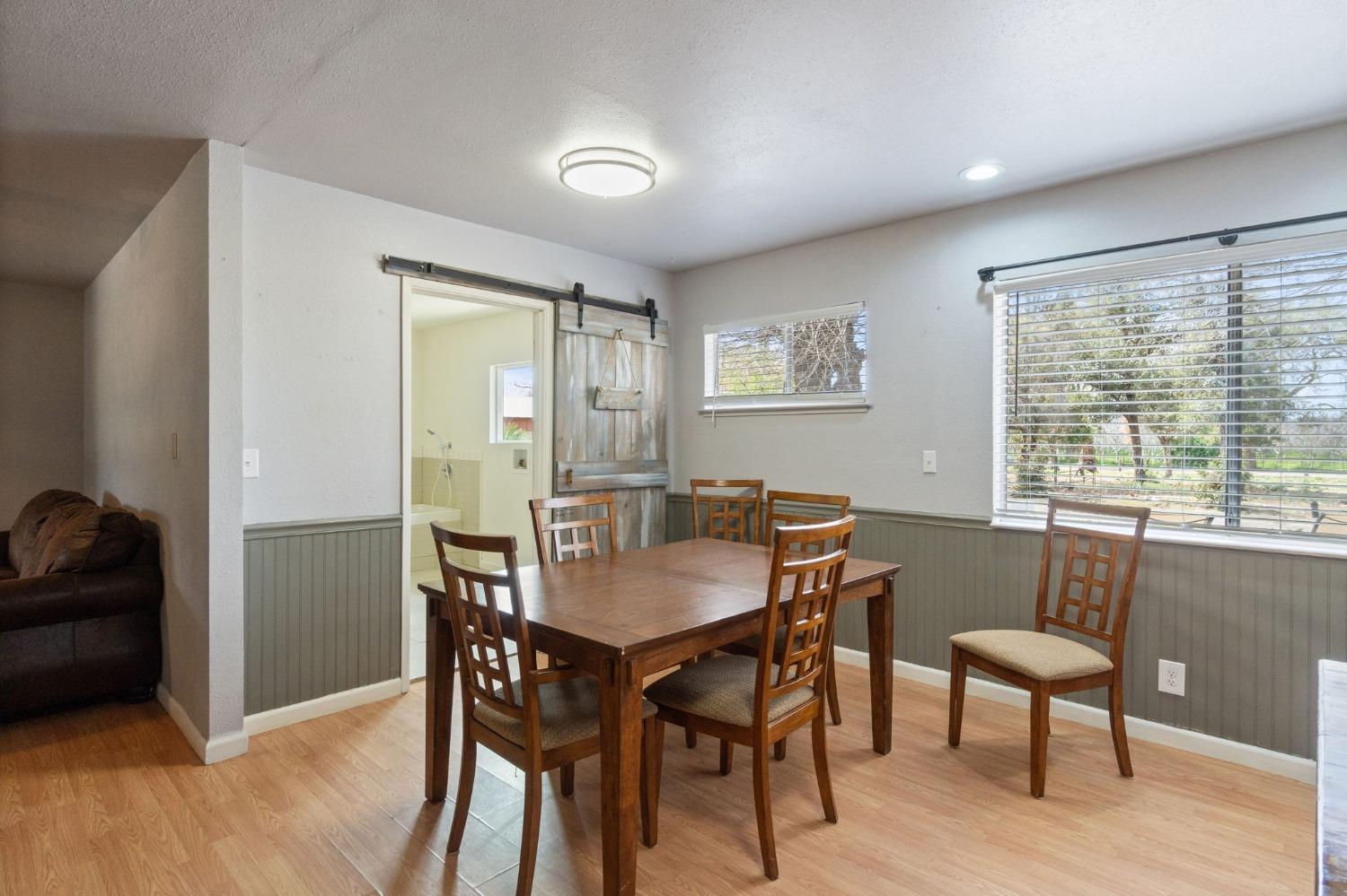 2244 Tivy Valley Road Sanger, CA 93657 - Photo 11 of 44 a view of a dining room with furniture window and wooden floor
