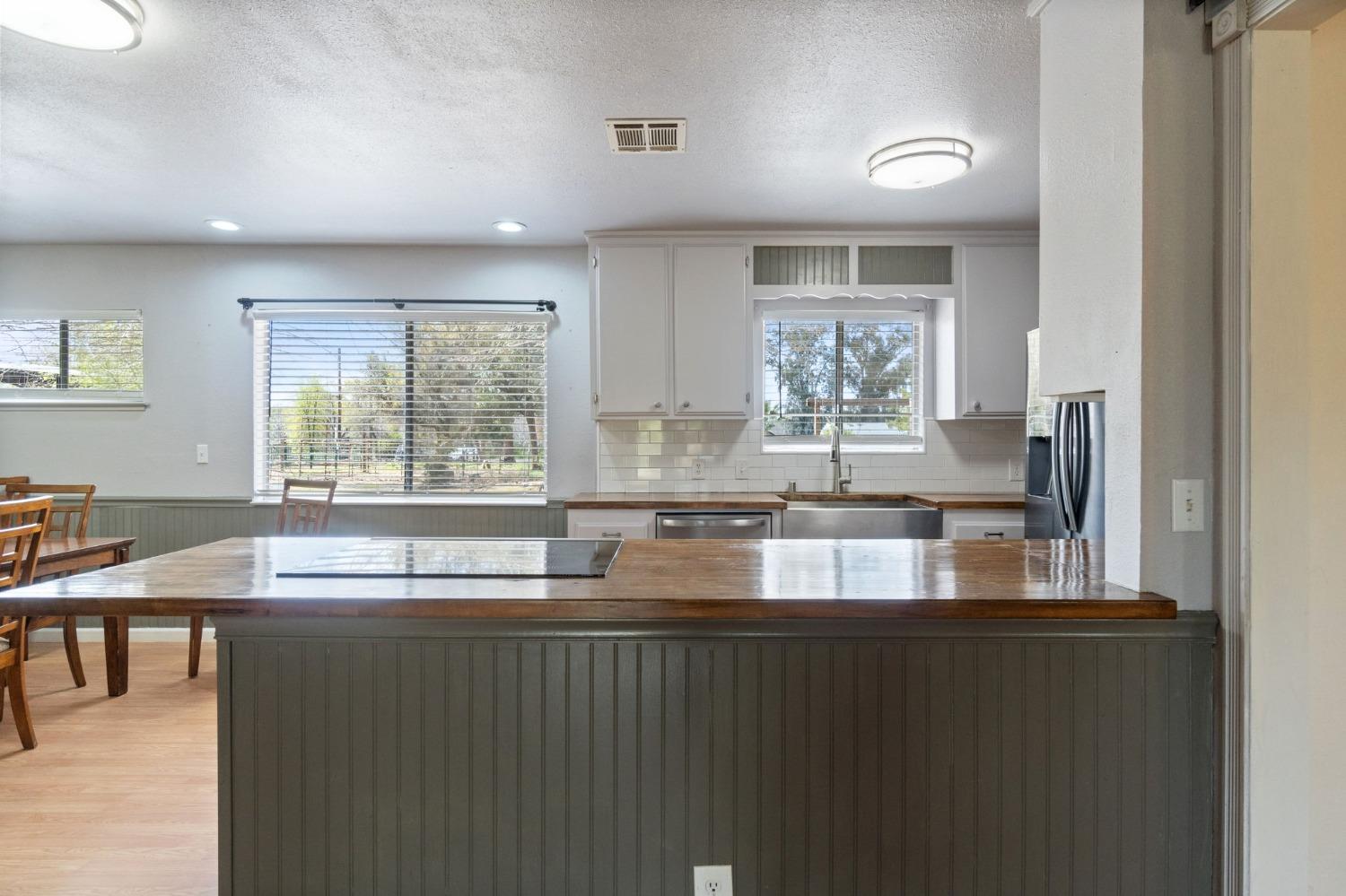 2244 Tivy Valley Road Sanger, CA 93657 - Photo 13 of 44 a kitchen with granite countertop a stove a sink and a window