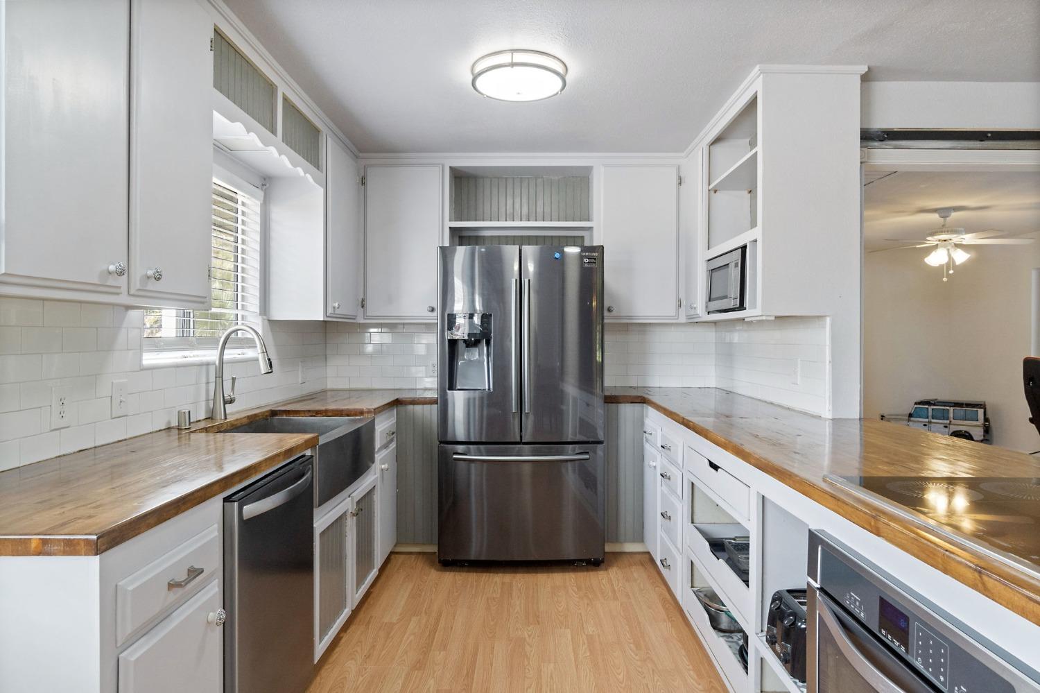2244 Tivy Valley Road Sanger, CA 93657 - Photo 14 of 44 a kitchen with granite countertop a refrigerator stove and sink