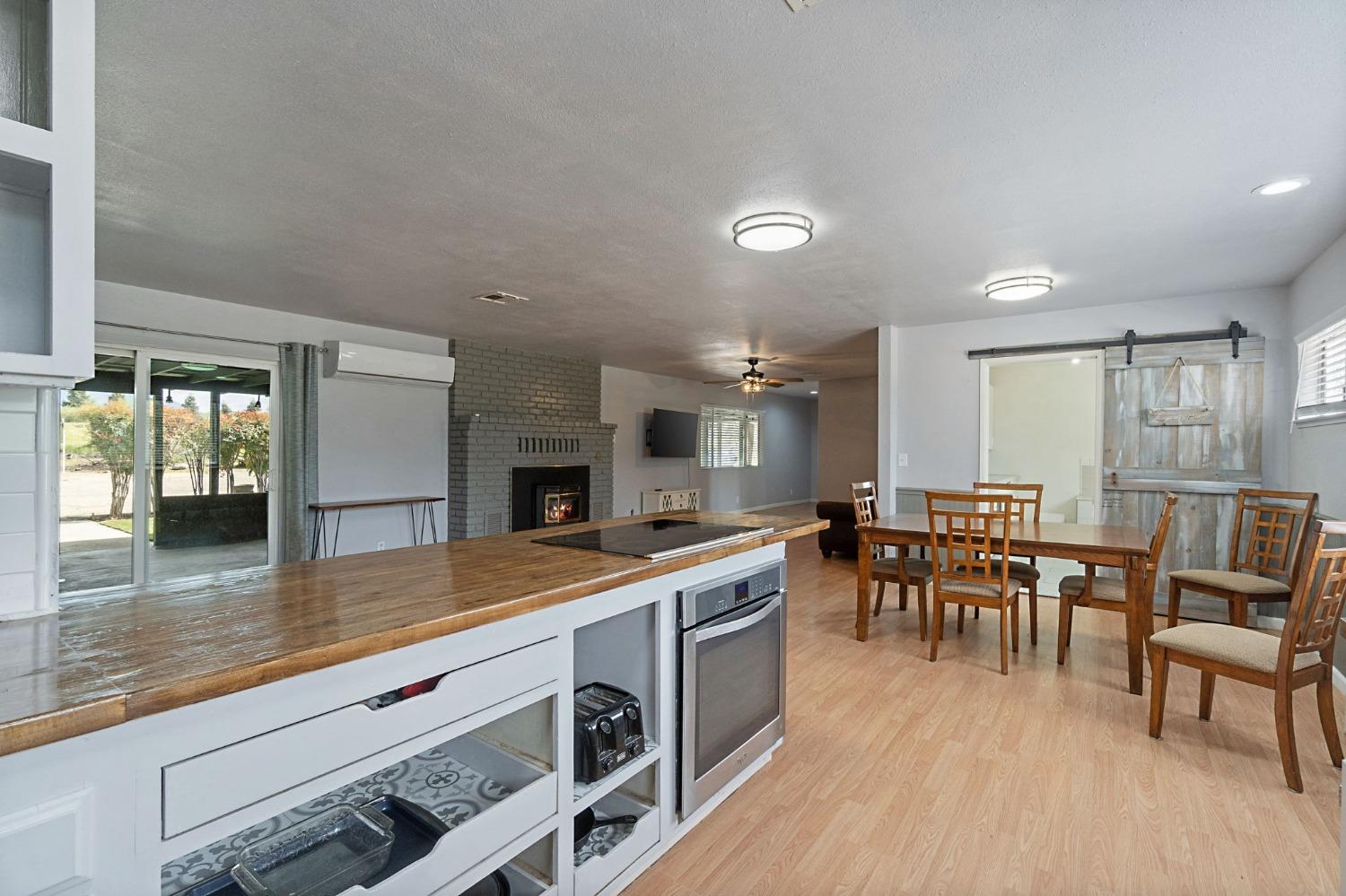 2244 Tivy Valley Road Sanger, CA 93657 - Photo 15 of 44 a view of dining room kitchen with furniture and wooden floor