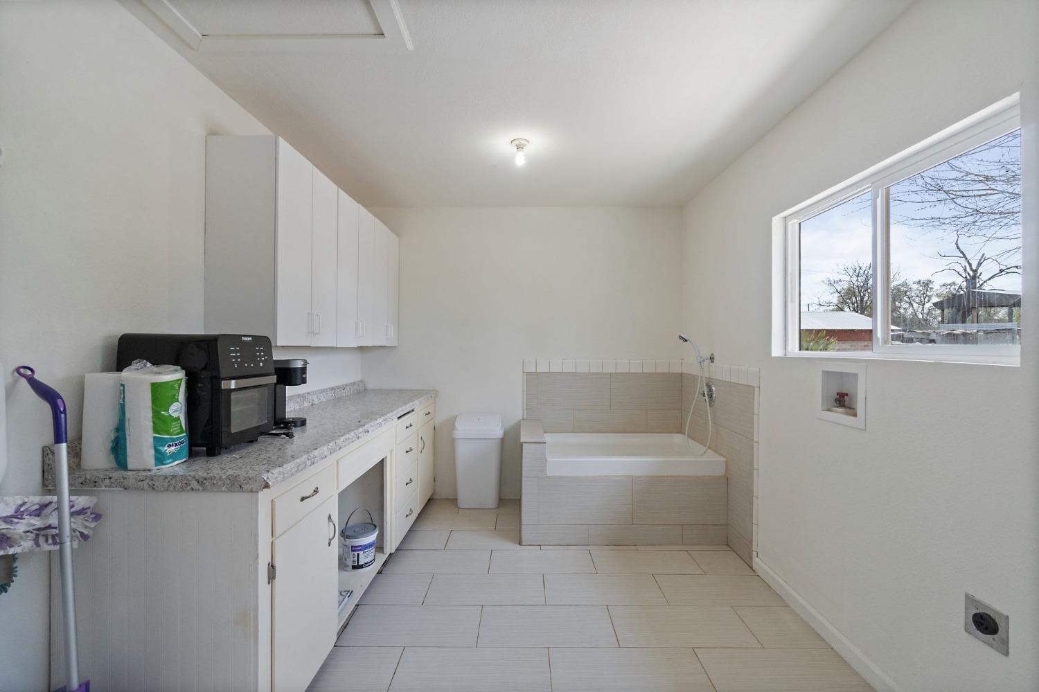2244 Tivy Valley Road Sanger, CA 93657 - Photo 16 of 44 a bathroom with a sink a bathtub and a shower