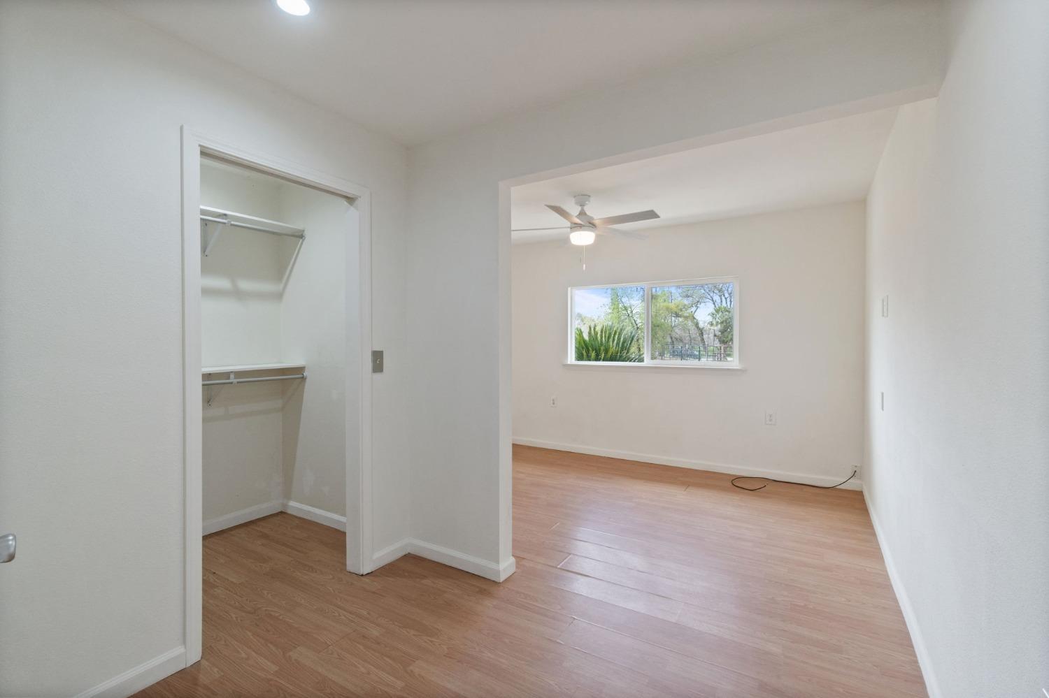 2244 Tivy Valley Road Sanger, CA 93657 - Photo 17 of 44 an empty room with wooden floor closet and windows