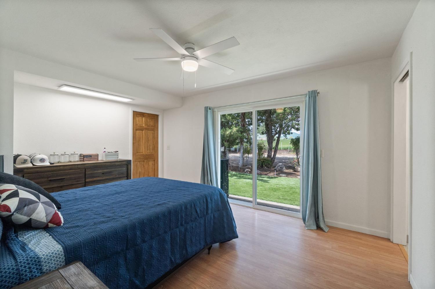 2244 Tivy Valley Road Sanger, CA 93657 - Photo 24 of 44 a bedroom with a bed and wooden floor