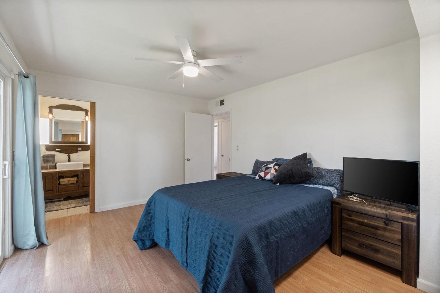 2244 Tivy Valley Road Sanger, CA 93657 - Photo 25 of 44 a bedroom with a bed and a flat screen tv