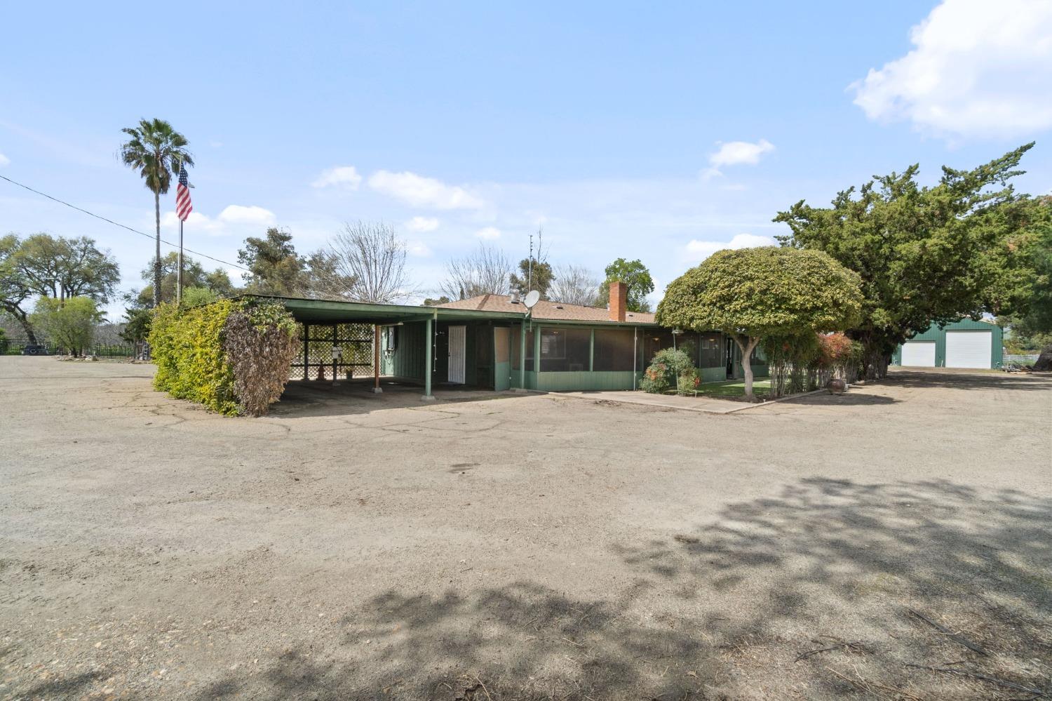 2244 Tivy Valley Road Sanger, CA 93657 - Photo 30 of 44 a front view of a house with a yard and potted plants