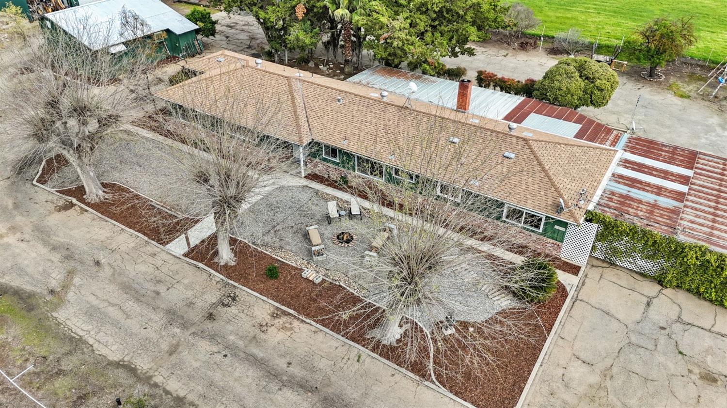 2244 Tivy Valley Road Sanger, CA 93657 - Photo 40 of 44 a white house with a large tree with yard