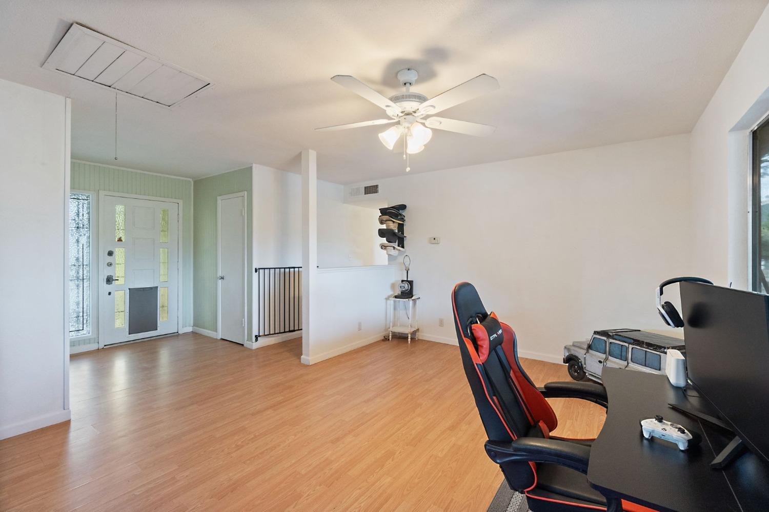 2244 Tivy Valley Road Sanger, CA 93657 - Photo 6 of 44 a view of a workspace with furniture and a chandelier