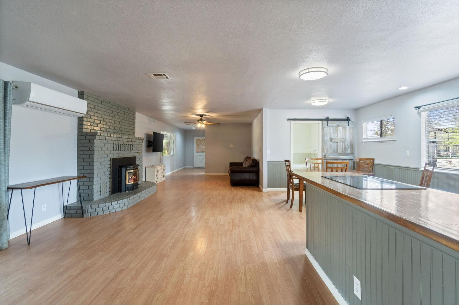 2244 Tivy Valley Road Sanger, CA 93657 - Photo 7 of 44 a large living room with stainless steel appliances granite countertop a couch and a fireplace