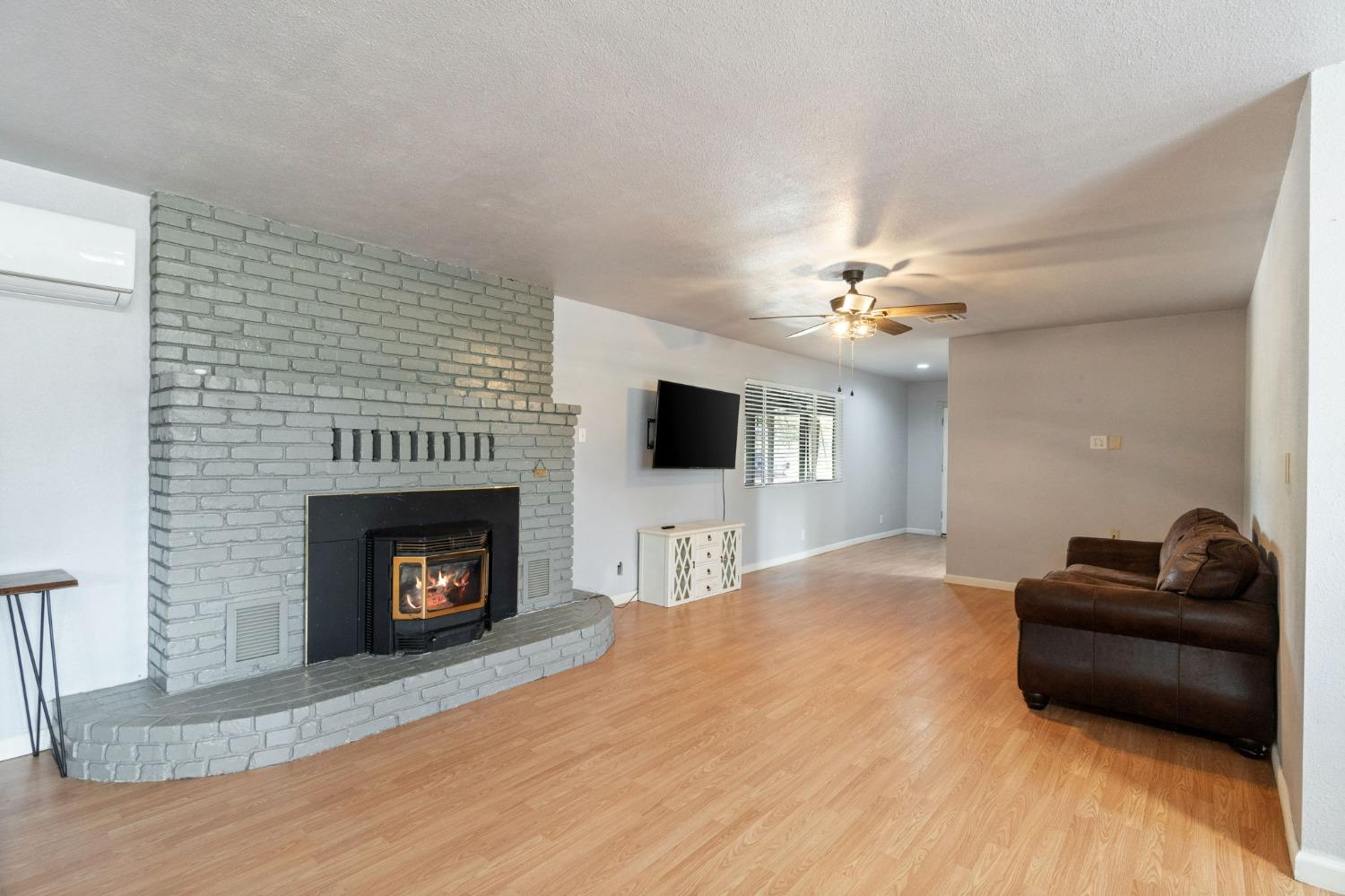 2244 Tivy Valley Road Sanger, CA 93657 - Photo 8 of 44 a living room with furniture and a fireplace