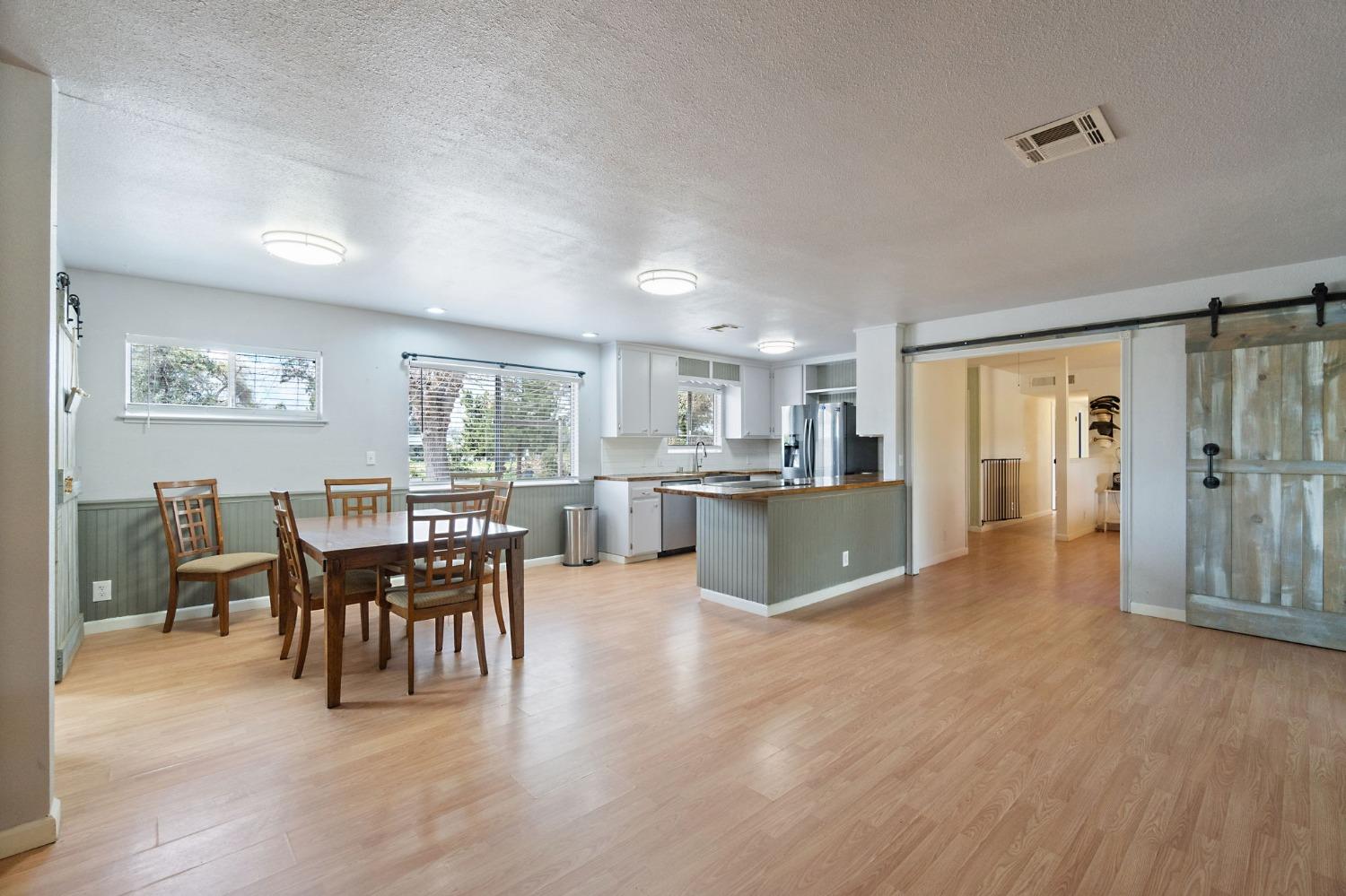2244 Tivy Valley Road Sanger, CA 93657 - Photo 10 of 44 a view of a dining room with furniture window and wooden floor