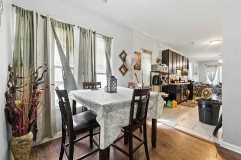 a view of a dining room with furniture and a window