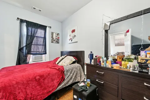 a bed room with a bed mirror and a window