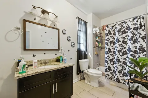 a bathroom with a sink toilet and shower