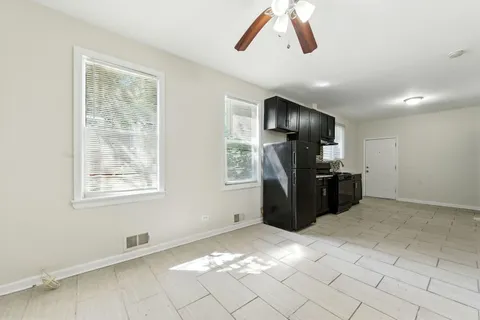 a kitchen with kitchen island a counter top space appliances and a window