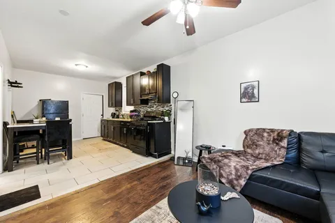 a living room with furniture and kitchen view