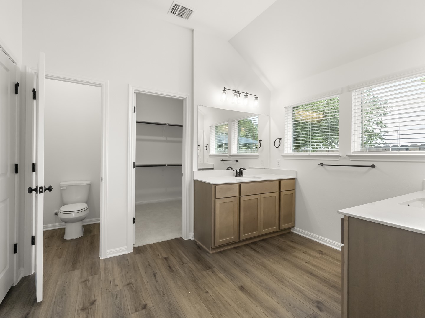 402 Judson Street Bertram, TX 78605 - Photo 16 of 27 a room with a white cabinets and wooden floors