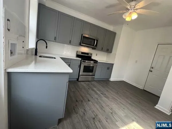 a kitchen with a sink appliances and cabinets