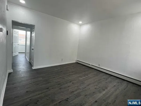 a view of an empty room and wooden floor