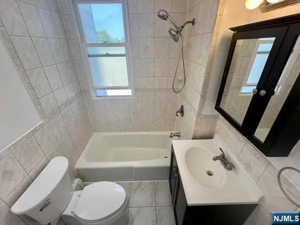a bathroom with a sink a toilet and bathtub