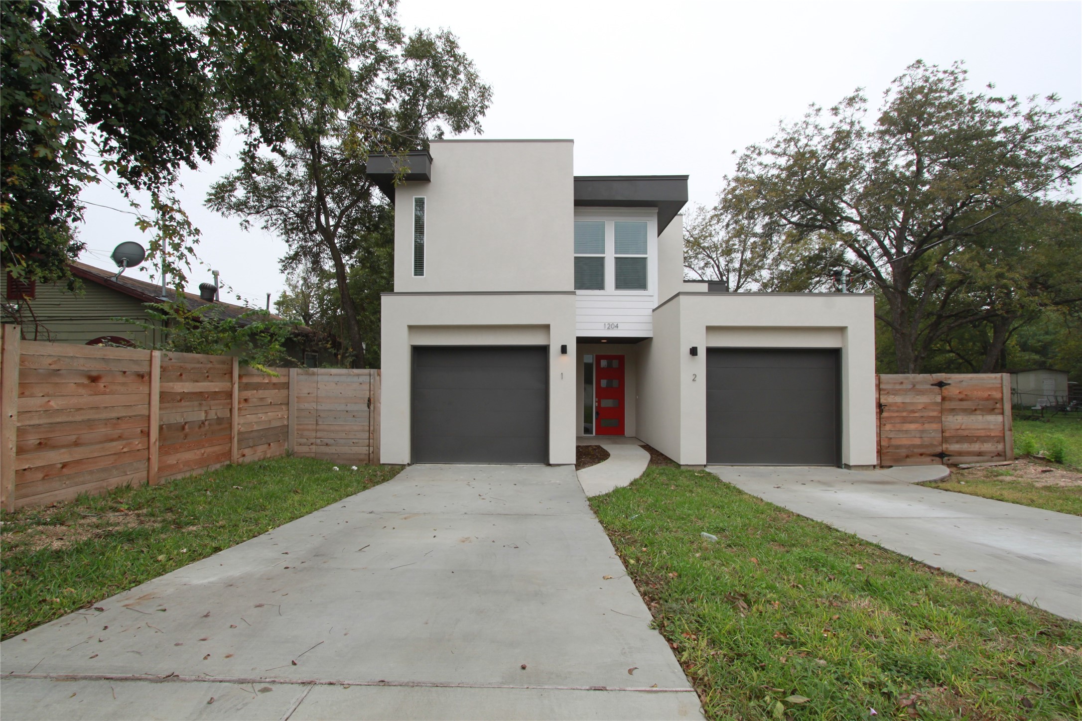 Contemporary home featuring stucco siding, concrete driveway, and a garage