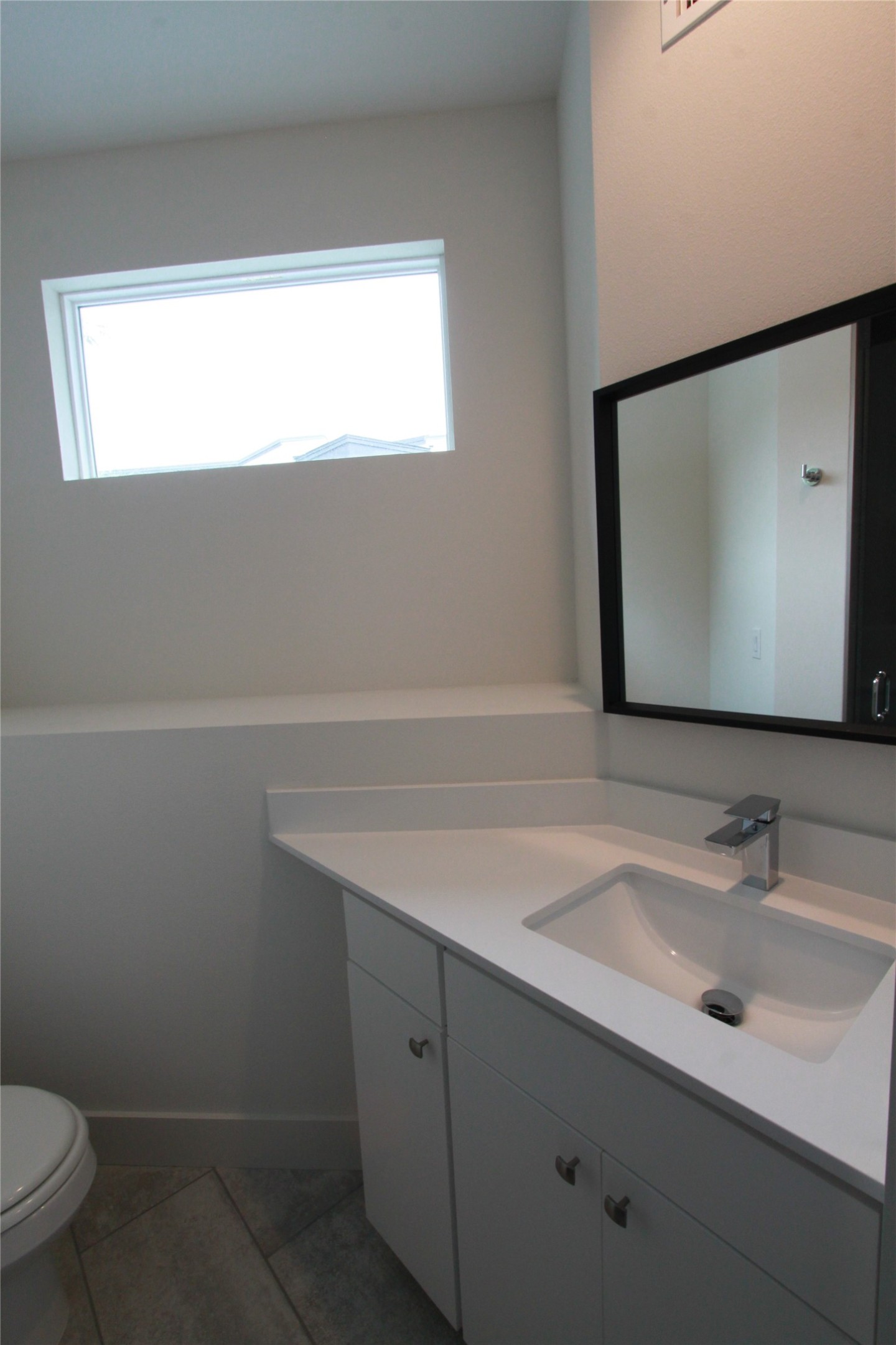 1204 Cometa Street, Unit A Austin, TX 78721 - Photo 30 of 38 Bathroom featuring vanity, plenty of natural light, and light tile patterned flooring