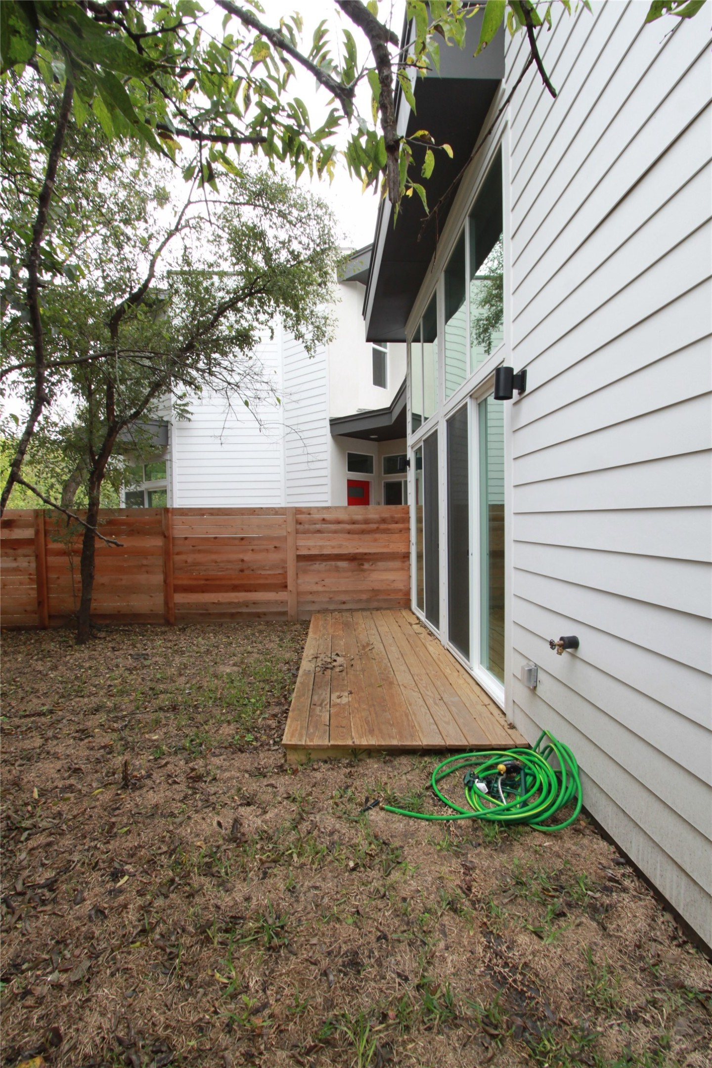 1204 Cometa Street, Unit A Austin, TX 78721 - Photo 37 of 38 Fenced backyard with a deck