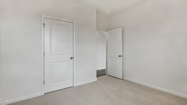 an empty room with closet area