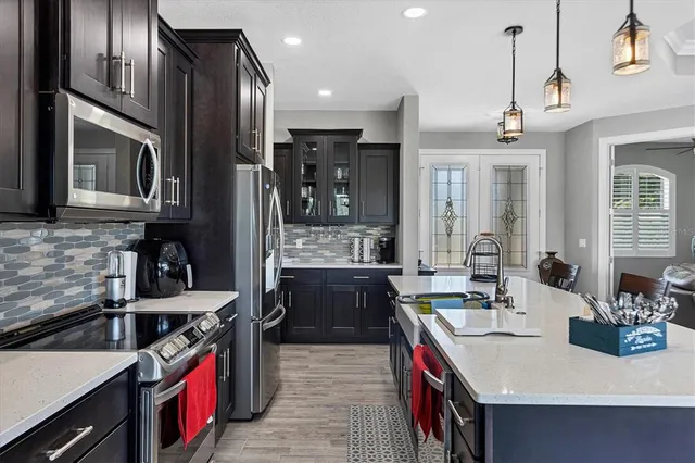 a kitchen with stainless steel appliances granite countertop a sink and stove