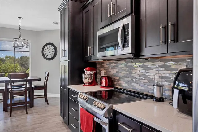 a kitchen with a stove and a wooden floor