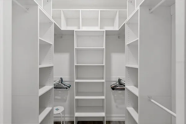 a view of walk in closet with empty racks