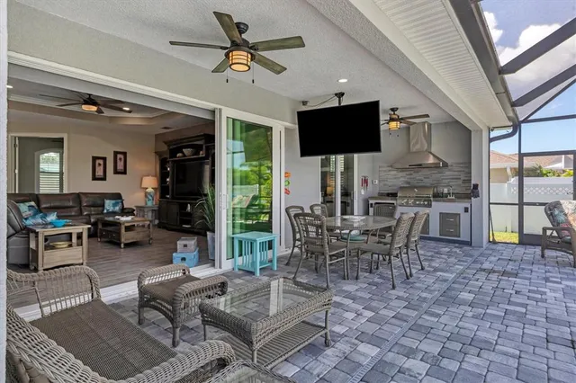 a living room with patio furniture and a flat screen tv